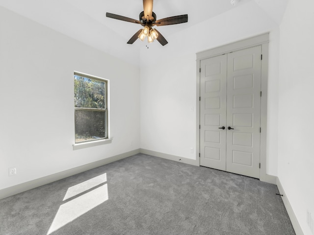 spare room with ceiling fan and light colored carpet