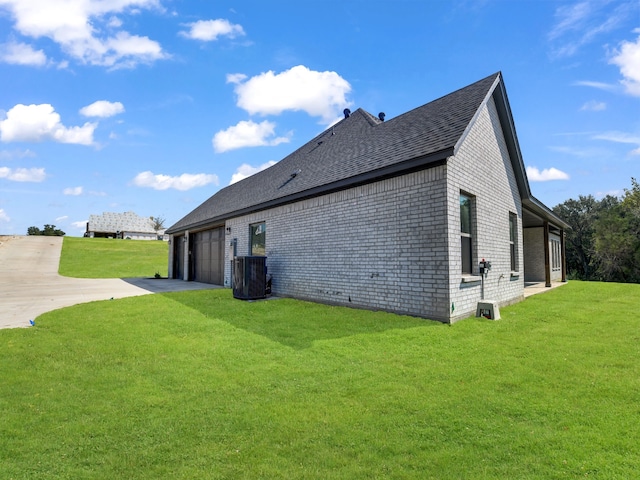 view of property exterior with central air condition unit, a lawn, and a garage