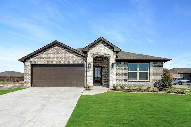 view of front facade with a garage and a front lawn