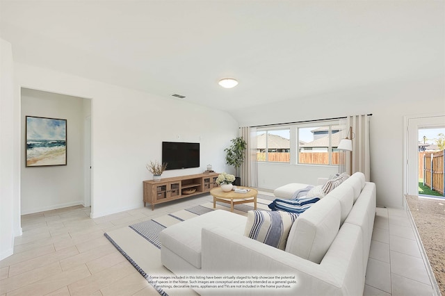 living room featuring vaulted ceiling