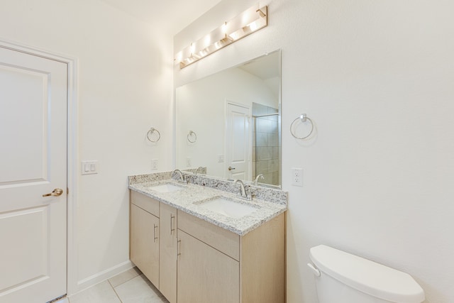 bathroom with walk in shower, vanity, toilet, and tile patterned floors