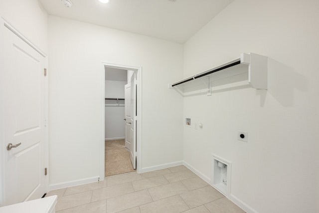 laundry area featuring gas dryer hookup, hookup for a washing machine, light tile patterned floors, and electric dryer hookup