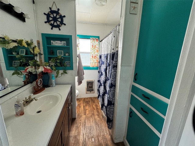 full bathroom featuring tile walls, shower / bath combo, toilet, vanity, and wood-type flooring