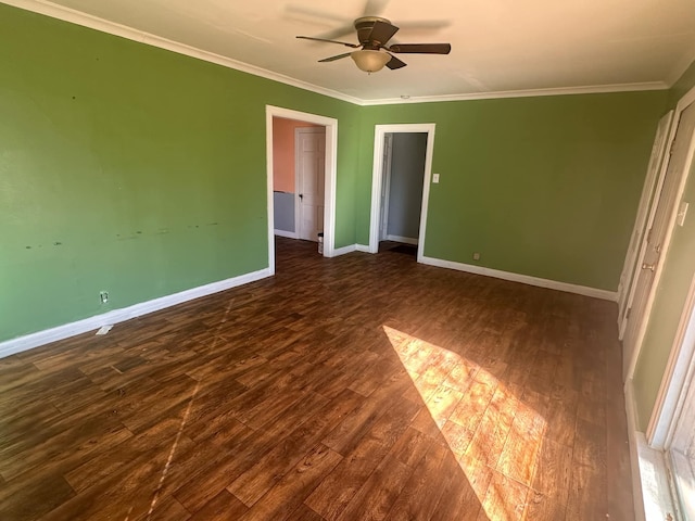 unfurnished bedroom featuring ornamental molding, dark hardwood / wood-style floors, and ceiling fan