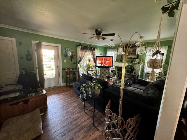 living room featuring dark hardwood / wood-style flooring, ornamental molding, and ceiling fan