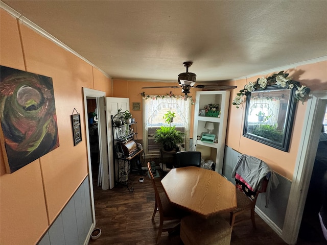 dining area featuring dark hardwood / wood-style floors, a textured ceiling, crown molding, and ceiling fan