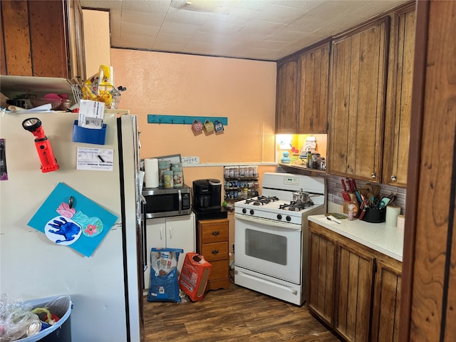 kitchen featuring dark hardwood / wood-style flooring and white appliances