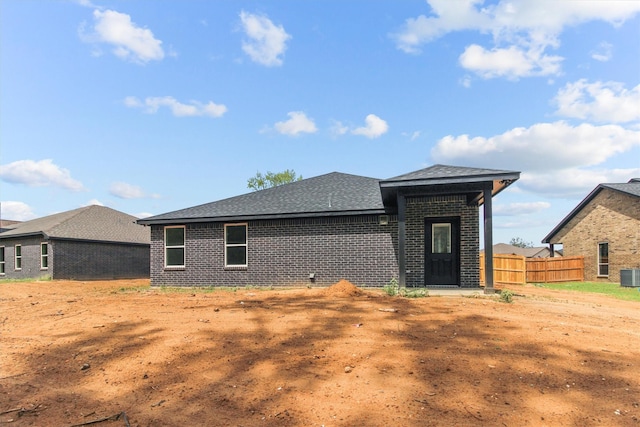 rear view of property with central AC unit