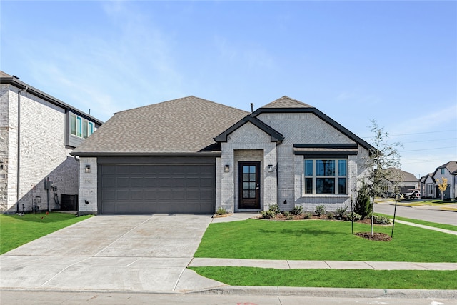 view of front of home with a garage and a front lawn