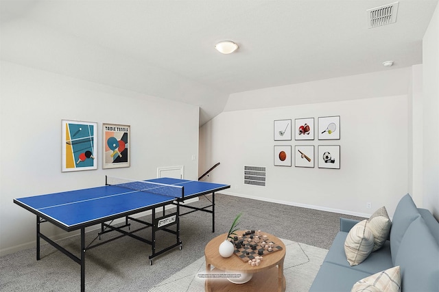 recreation room featuring carpet floors and vaulted ceiling