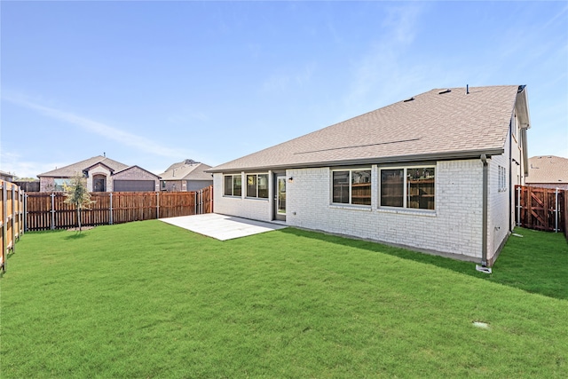 back of house with a yard and a patio