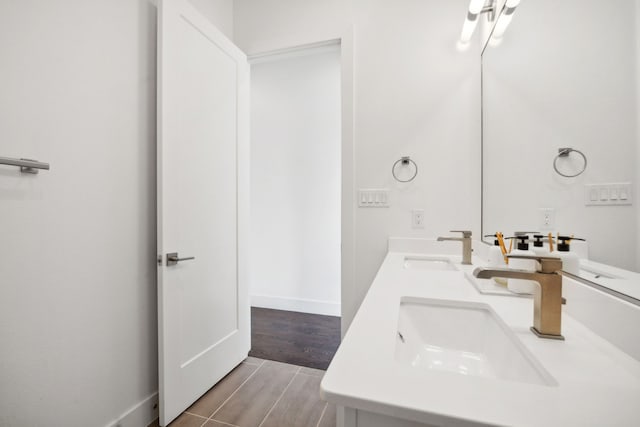 bathroom with hardwood / wood-style floors and dual bowl vanity