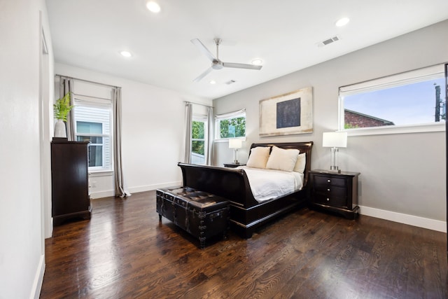 bedroom with dark wood-type flooring, ceiling fan, and multiple windows