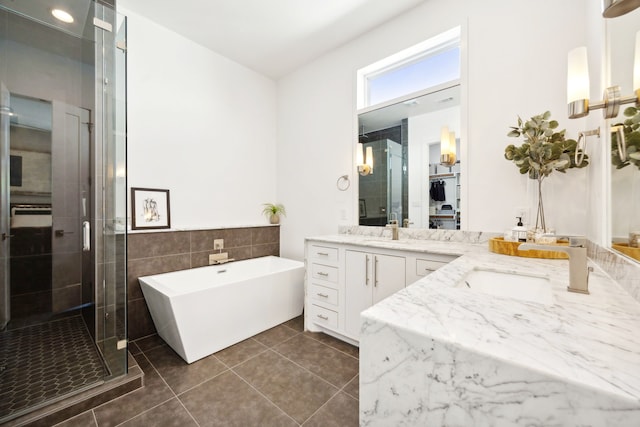 bathroom with plus walk in shower, tile patterned flooring, and dual bowl vanity