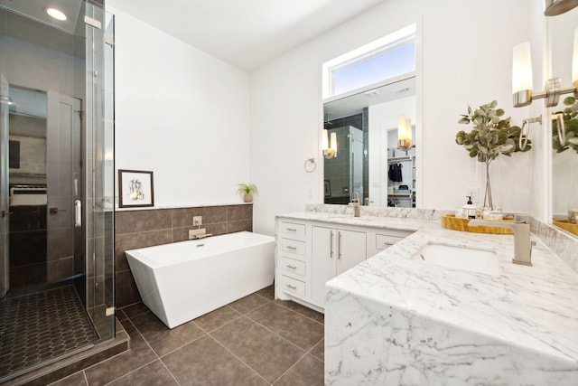 bathroom featuring tile patterned floors, vanity, separate shower and tub, and tile walls