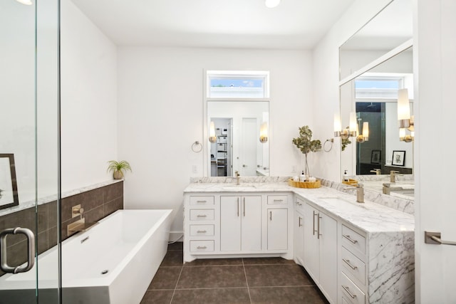 bathroom with a tub to relax in, tile patterned flooring, and dual bowl vanity