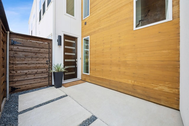 view of exterior entry featuring a patio area