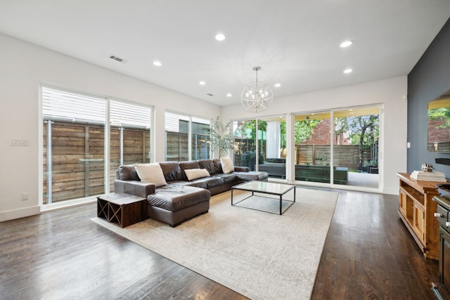 living room with a chandelier and dark hardwood / wood-style floors