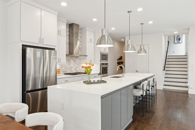 kitchen featuring appliances with stainless steel finishes, pendant lighting, and a large island