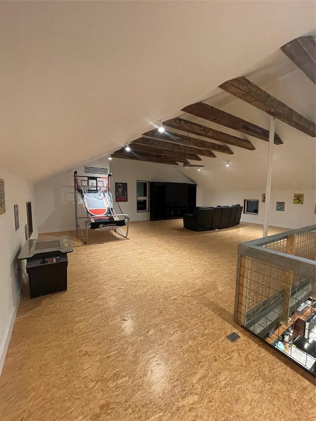 recreation room with vaulted ceiling with beams