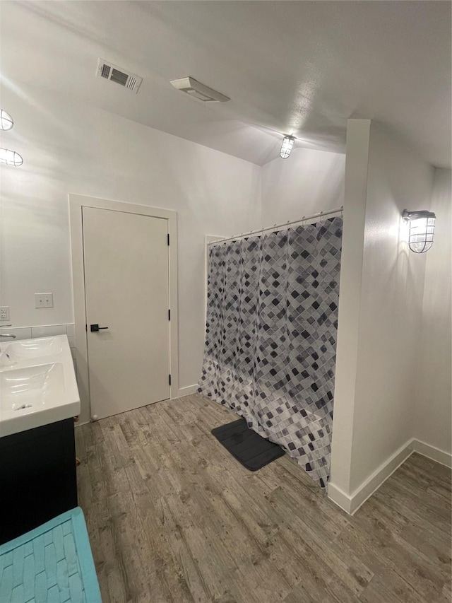 bathroom featuring vanity, curtained shower, and hardwood / wood-style floors