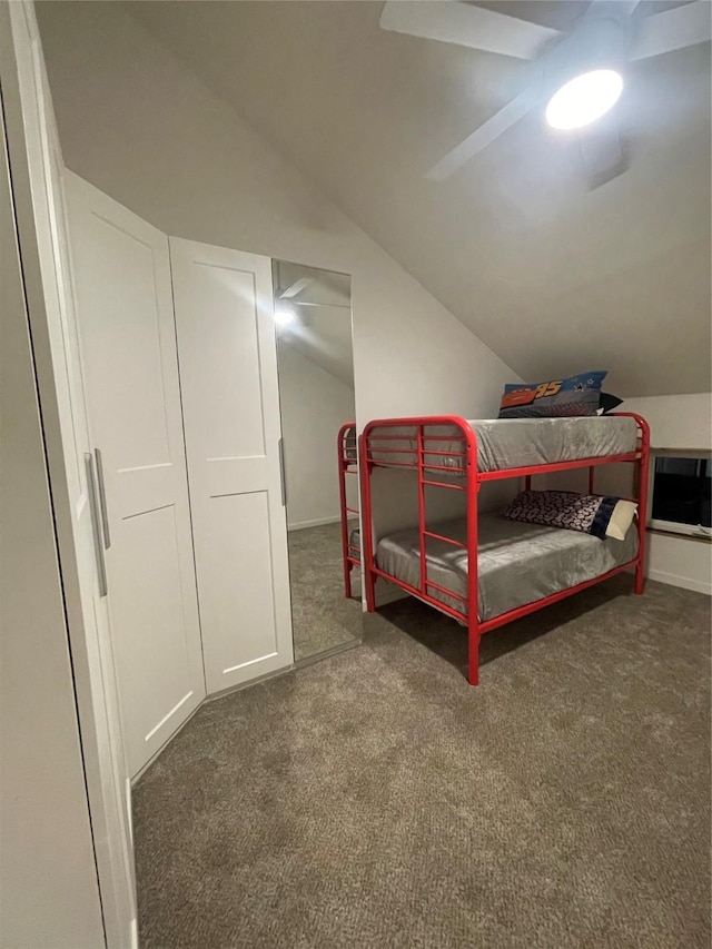 carpeted bedroom featuring ceiling fan, a closet, and lofted ceiling