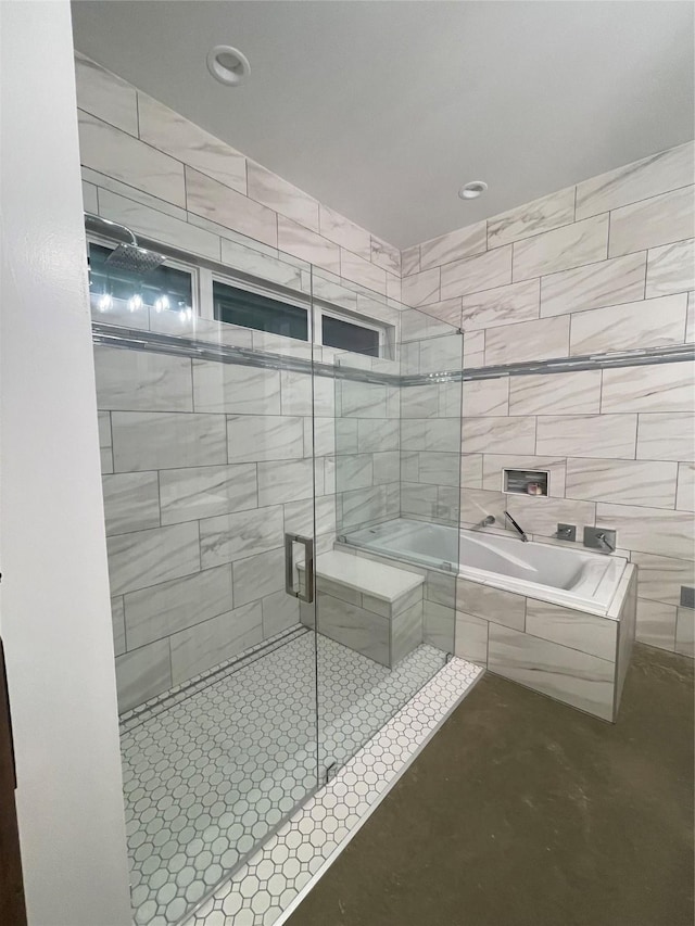 bathroom featuring shower with separate bathtub