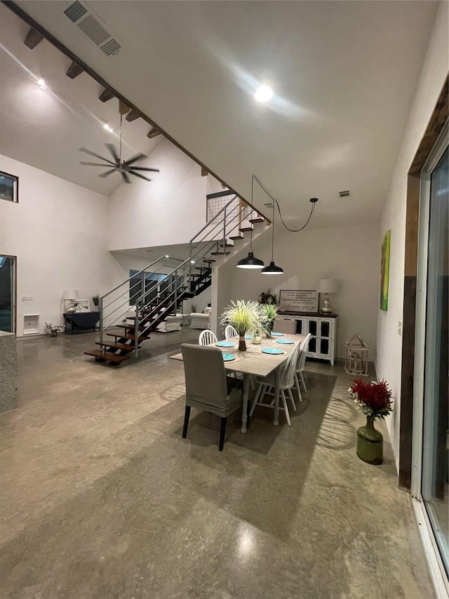 dining room with ceiling fan and concrete flooring