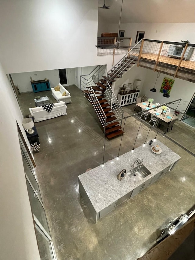 interior space with ceiling fan and concrete floors