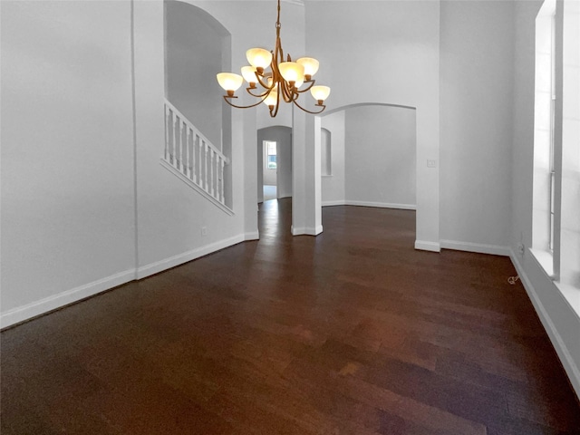 interior space featuring dark wood-type flooring and a chandelier