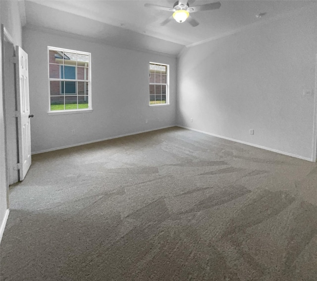 empty room with ceiling fan and carpet