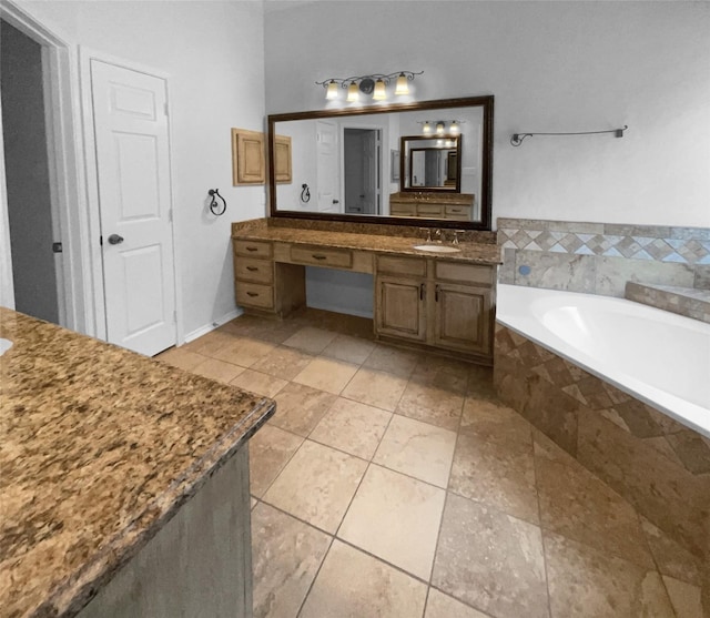 bathroom with vanity, a relaxing tiled tub, and tile patterned floors