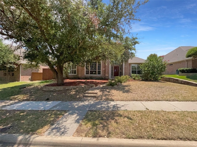 obstructed view of property featuring a front yard