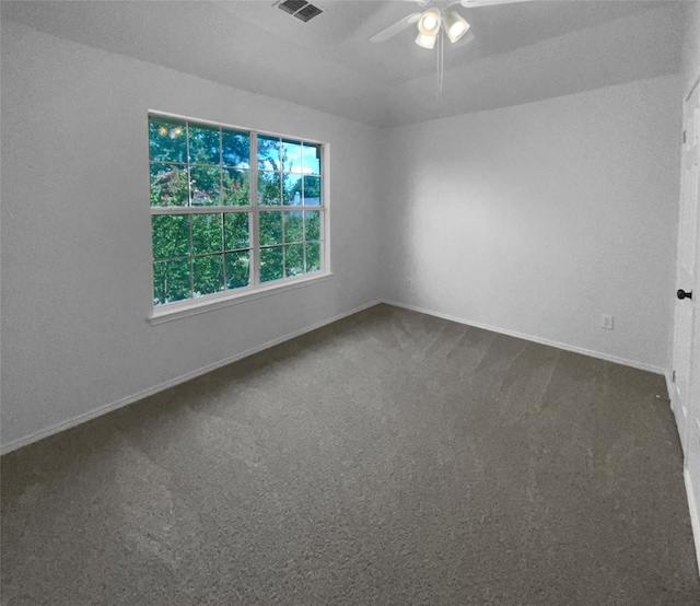 carpeted spare room featuring ceiling fan