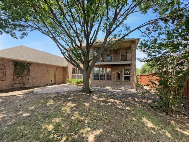 back of property featuring a patio and a balcony