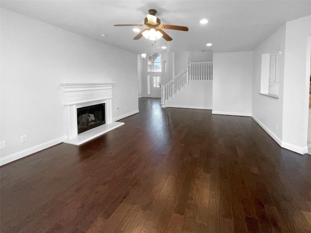 unfurnished living room featuring dark hardwood / wood-style floors and ceiling fan