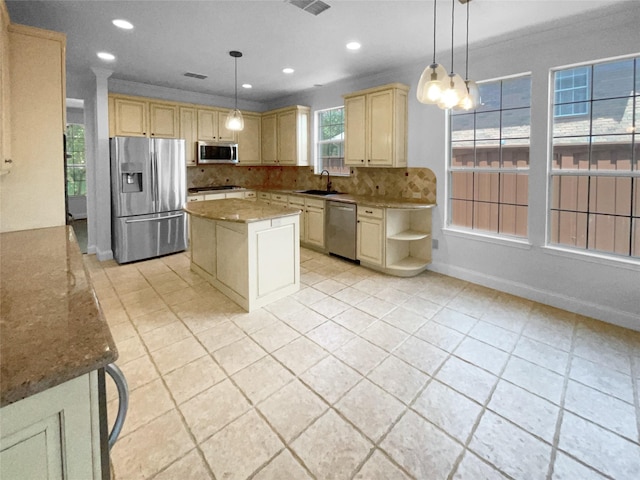 kitchen with a kitchen island, decorative light fixtures, sink, backsplash, and stainless steel appliances