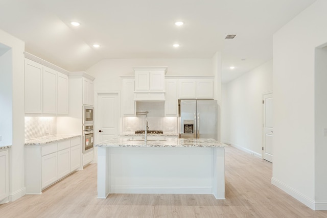 kitchen featuring appliances with stainless steel finishes, light hardwood / wood-style floors, and white cabinetry