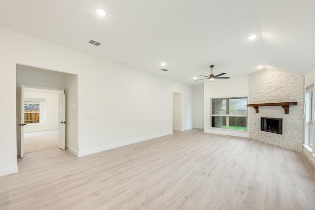 unfurnished living room with ceiling fan, light hardwood / wood-style floors, a fireplace, and vaulted ceiling