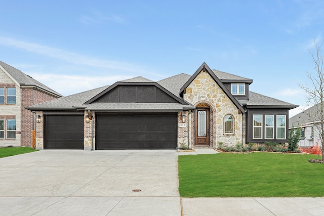 view of front of house featuring a garage and a front lawn