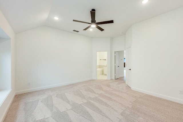 carpeted spare room featuring ceiling fan and vaulted ceiling