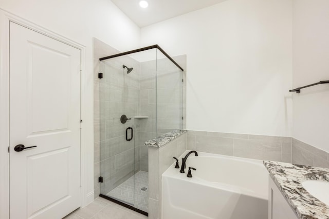 bathroom with plus walk in shower, vanity, and tile patterned floors