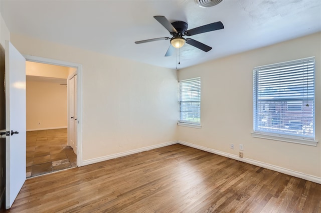 spare room featuring ceiling fan and hardwood / wood-style floors