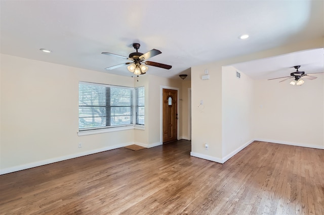 unfurnished room with ceiling fan and hardwood / wood-style floors