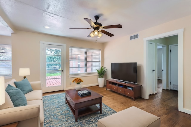 living room with wood-type flooring and ceiling fan