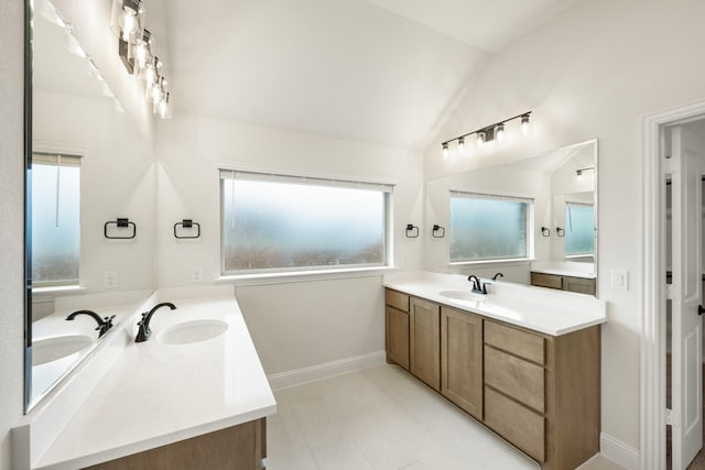 bathroom with lofted ceiling and vanity