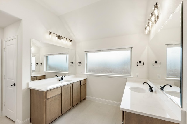 bathroom featuring lofted ceiling, vanity, and tile patterned floors