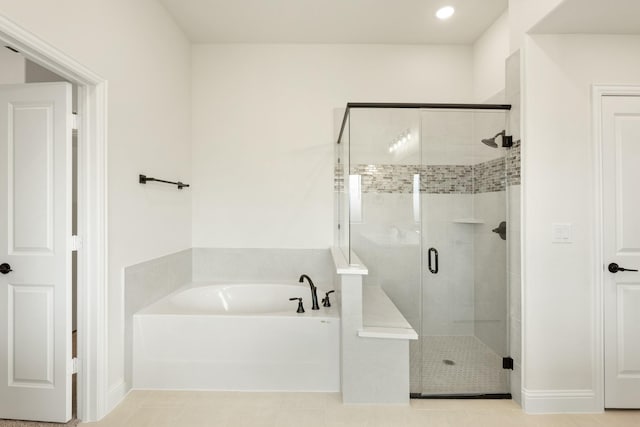 bathroom with tile patterned floors and independent shower and bath