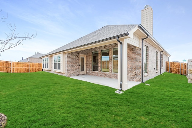 back of property featuring a yard and a patio area