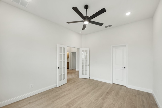 unfurnished bedroom featuring ceiling fan, light wood-type flooring, and french doors